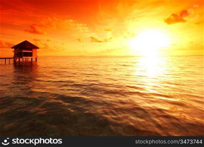 resort maldivian houses on sunrise