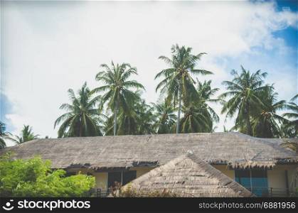 Resort roof and coconut trees. Vintage filter