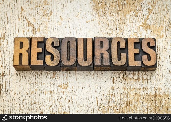 resources word in vintage letterpress wood type on a grunge painted barn wood background