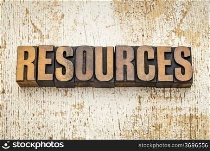resources word in vintage letterpress wood type on a grunge painted barn wood background