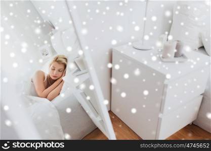 rest, comfort and people concept - mirror reflection of young woman sleeping in bed at home bedroom over snow