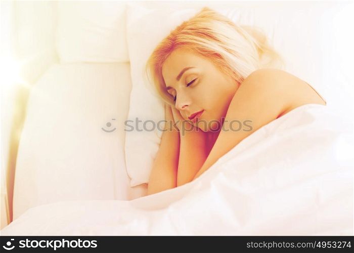 rest, comfort and people concept - young woman sleeping in bed at home bedroom. young woman sleeping in bed at home bedroom