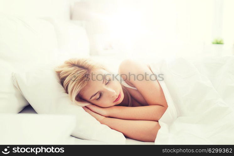 rest, comfort and people concept - young woman sleeping in bed at home bedroom. young woman sleeping in bed at home bedroom