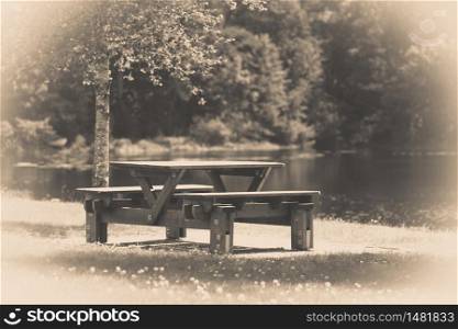 Rest place in park, picnic table in peaceful surrounding by water perfects for outdoor relax. Rest place in park, picnic table in peaceful surrounding