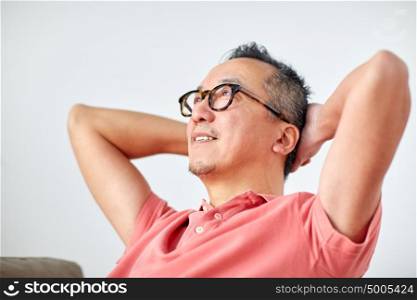rest, relax and people concept - man in glasses relaxing or dreaming at home. man in glasses relaxing or dreaming at home