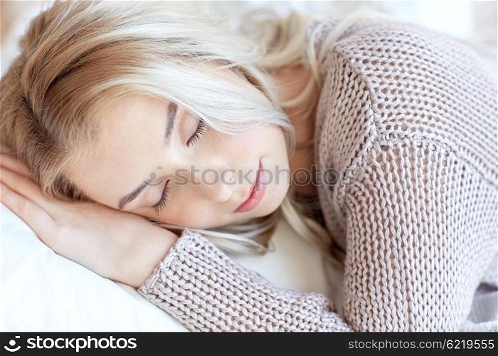 rest, relax, dream and people concept - young woman or teenage girl sleeping on pillow at home