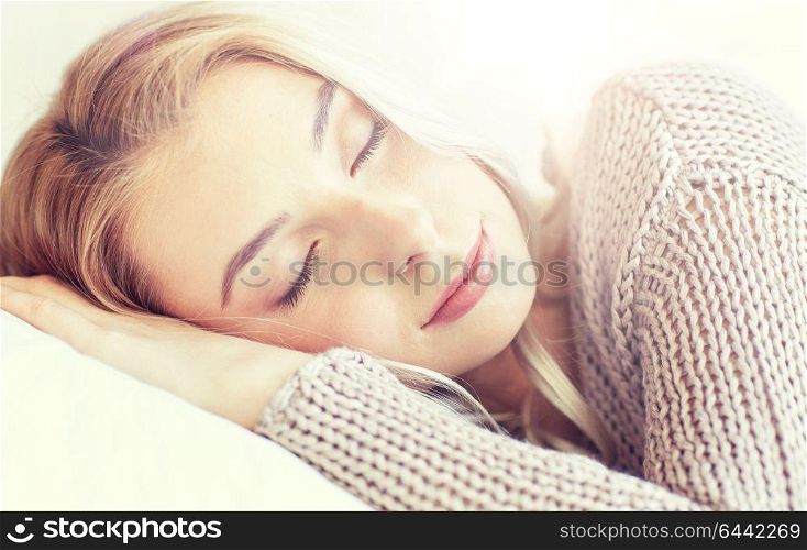 rest, relax, dream and people concept - young woman or teenage girl sleeping on pillow at home. woman or teenage girl sleeping on pillow at home