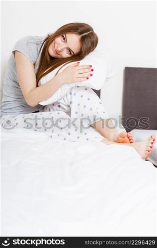 Rest relax recovery sleep dream concept. Tired girl hugging pillow. Young exhausted lady relaxing sleeping dreaming in bed.. Tired girl hugging pillow.