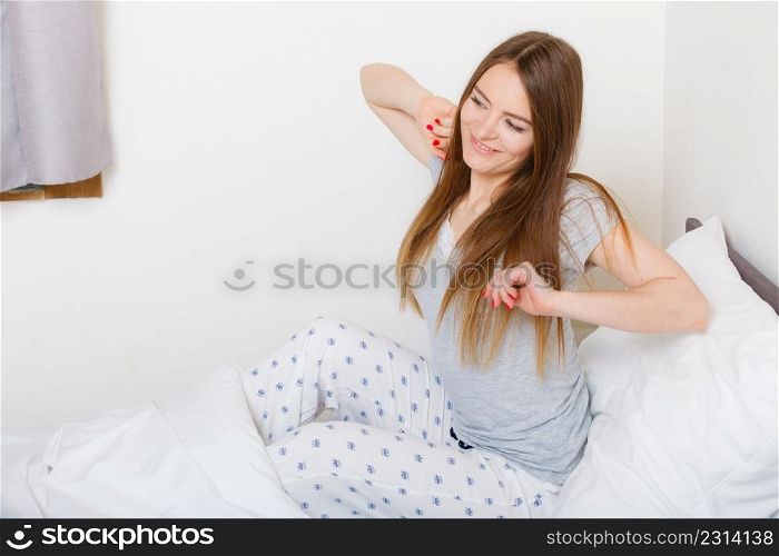 Rest relax sleep dreaming comfort concept. Girl yawning in bed. Young lady stretching after waking up during morning.. Girl yawning in bed.