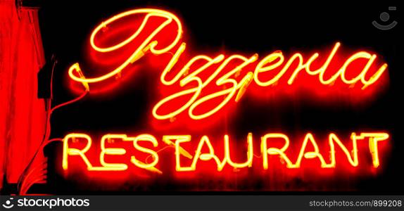 Restaurant and pizzeria sign in neon lights