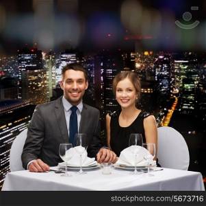 restaurant, couple and holiday concept - smiling couple holding hands at restaurant