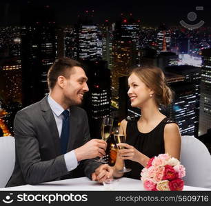 restaurant, couple and holiday concept - smiling couple with glass of champagne looking at each other at restaurant