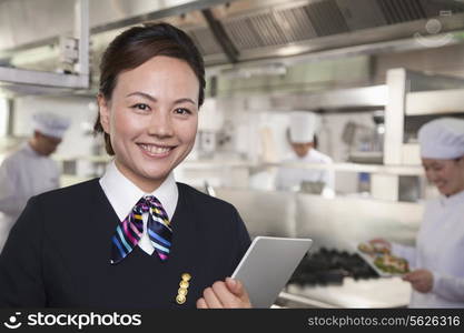 Restaurant Hostess in an Industrial Kitchen