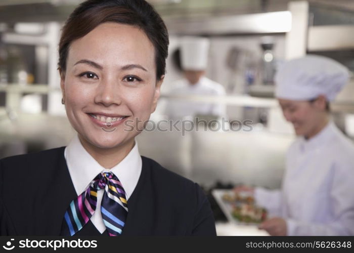 Restaurant Hostess in an Industrial Kitchen