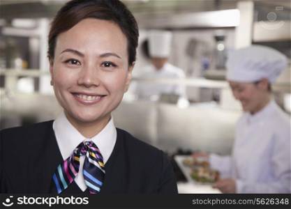 Restaurant Hostess in an Industrial Kitchen