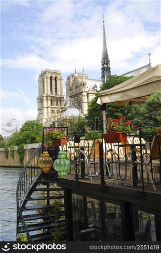 Restaurant on a boat on river Seine with the view of Notre Dame de Paris Cathedral in Paris France