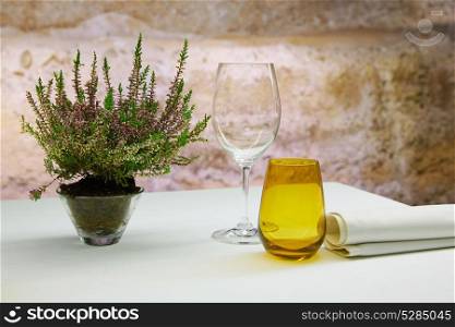 Restaurant table with mediterranean herbs and stone background