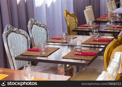 restaurant tables antique French style palace prepared with cutlery and glasses