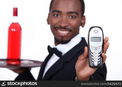 Restaurant waiter holding telephone