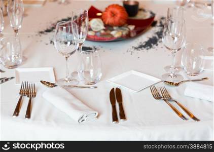 Restaurant with table settings for a dinner party