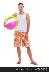 Resting on vacation smiling young man with beach ball