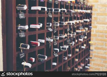 Resting wine bottles stacked on wooden racks in cellar