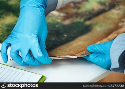 Restoring Oil Painting Canvas. Restoration expert revitalizing crumpled canvas on a damaged oil painting. Restoring Oil Painting Canvas