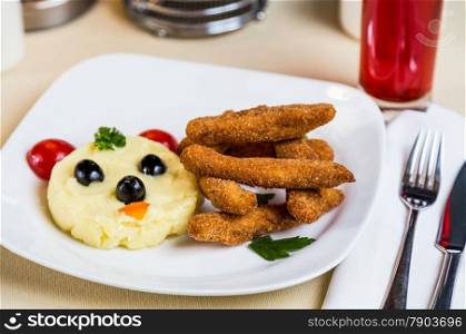 Restourant serving dish for child`s menu - potato puree, stick with face