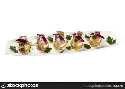 Restourant serving dish - pieces herring for snack on white background