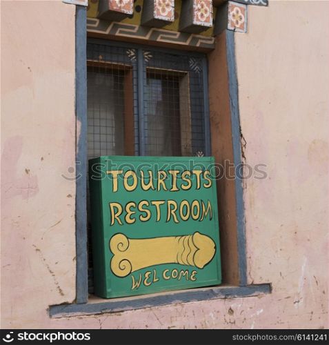 Restroom sign on window, Sopsokha Village, Punakha, Bhutan