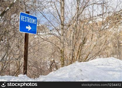 restrooms sign in one of rest areas in Glenwood Canyon, Colorado in winter scenery, travel concept