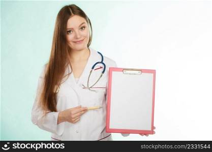 Results and information of treatment. Young female doctor holding empty folder with files of desease illness. Specialist point by pen blank clipboard. Woman in medical uniform with stethoscope.. Young doctor with folder