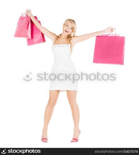 retail and sale concept - elegant woman in dress and high heels with shopping bags
