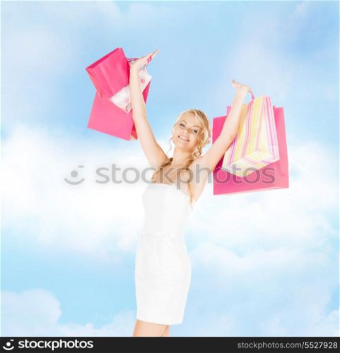 retail and sale concept - elegant woman in dress and high heels with shopping bags