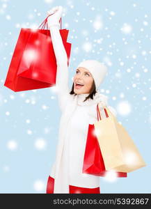 retail and sale concept - happy woman in winter clothes with shopping bags