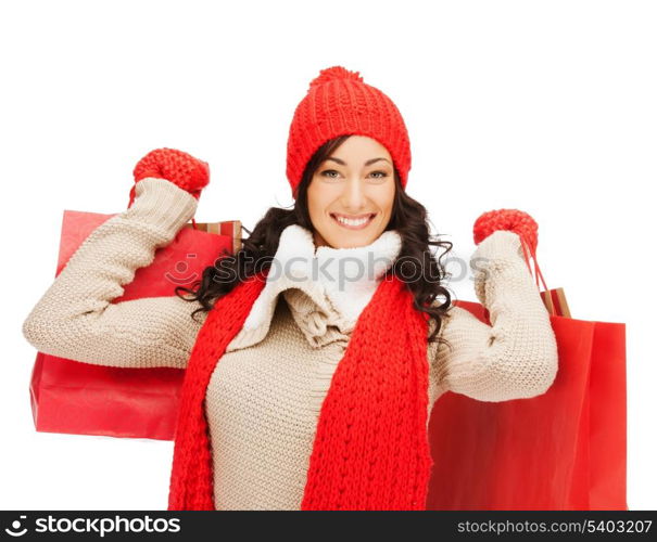 retail and sale concept - happy woman in winter clothes with shopping bags