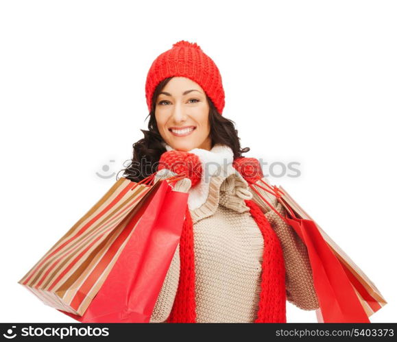 retail and sale concept - happy woman in winter clothes with shopping bags