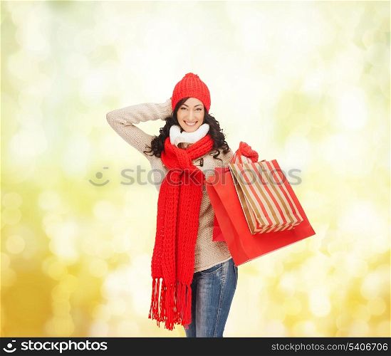 retail and sale concept - happy woman in winter clothes with shopping bags