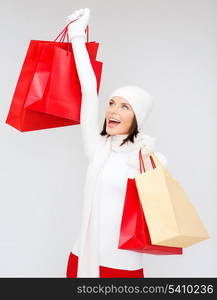 retail and sale concept - happy woman in winter clothes with shopping bags