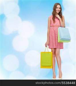 retail and sale concept - smiling woman in dress and high heels with many shopping bags