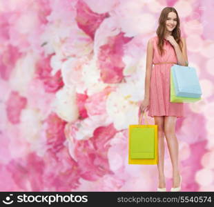 retail and sale concept - smiling woman in dress and high heels with many shopping bags