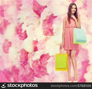 retail and sale concept - smiling woman in dress and high heels with many shopping bags