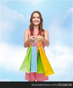 retail and sale concept - smiling woman in dress with many shopping bags