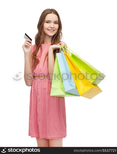 retail and sale concept - smiling woman in dress with many shopping bags and credit card