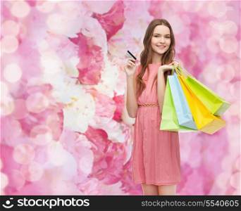 retail and sale concept - smiling woman in dress with many shopping bags and credit card