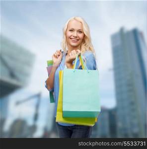 retail and sale concept - smiling woman with many shopping bags