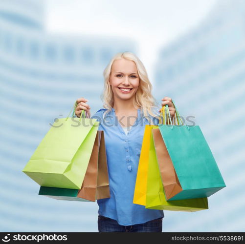 retail and sale concept - smiling woman with many shopping bags