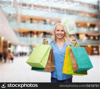 retail and sale concept - smiling woman with many shopping bags
