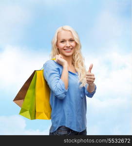 retail, gesture and sale concept - smiling woman with many shopping bags showing thumbs up