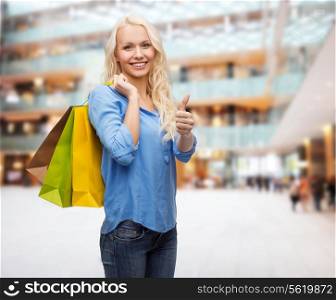 retail, gesture and sale concept - smiling woman with many shopping bags showing thumbs up